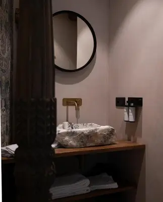 a bathroom with a sink and a mirror at Nonam Boutique Hotel Gent in Ghent