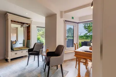 a home office with a desk and chairs and a mirror at B&B Hof Ter Koningen in Aalst
