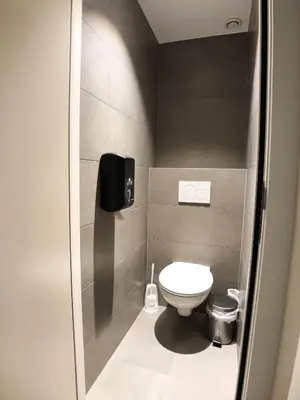 a small bathroom with a toilet and a shower at HI Brussels Generation Europe Hostel in Brussels