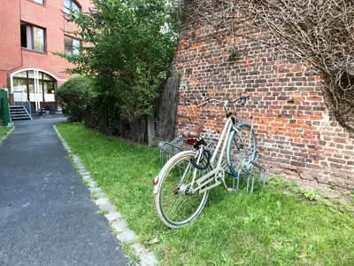 a bike parked next to a brick wall at HI Brussels Generation Europe Hostel in Brussels