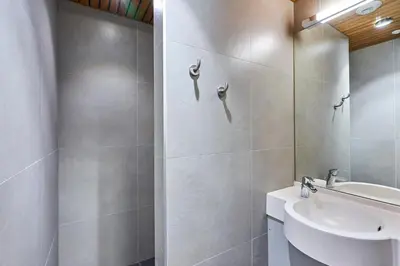 a white bathroom with a sink and a toilet at HI Brussels Jacques Brel Hostel in Brussels