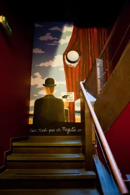 a poster of a man sitting on the stairs at HI Brussels Jacques Brel Hostel in Brussels
