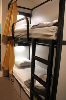 a room with two bunk beds and a ladder at HI Brussels Jacques Brel Hostel in Brussels