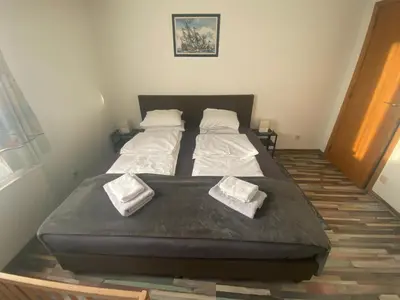 a bed in a room with two pillows on it at Privé appartement in de buurt van Brussel in Asse