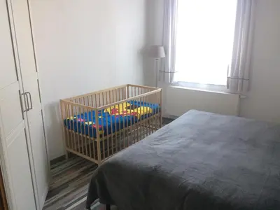 a bedroom with a crib with toys in it at Privé appartement in de buurt van Brussel in Asse