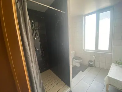 a bathroom with a shower and a toilet at Privé appartement in de buurt van Brussel in Asse