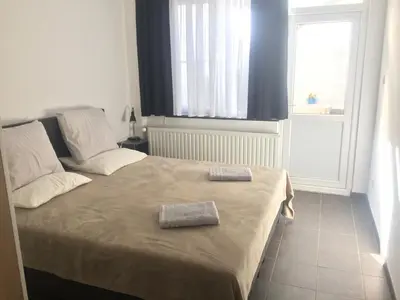a bedroom with a bed with two towels on it at Private apartment near Brussels in Asse