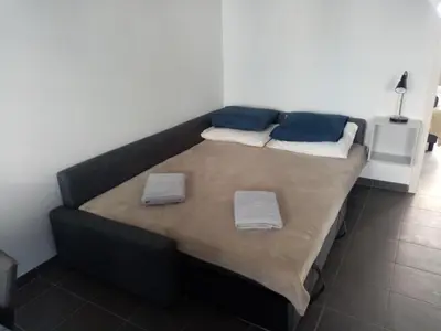 a bed with two pillows on it in a room at Private apartment near Brussels in Asse