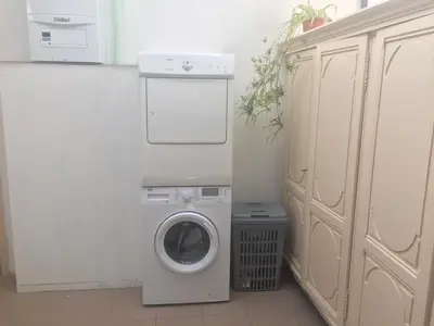 a washer and dryer in a white laundry room at Private apartment near Brussels in Asse