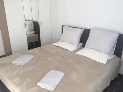 a large bed with two white towels on it at Private apartment near Brussels in Asse