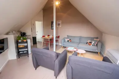a living room with a couch and chairs and a table at SHWAY - The Suit in Antwerp