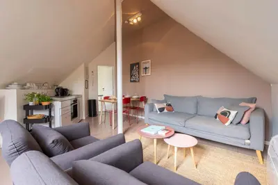a living room with a blue couch and a table at SHWAY - The Suit in Antwerp