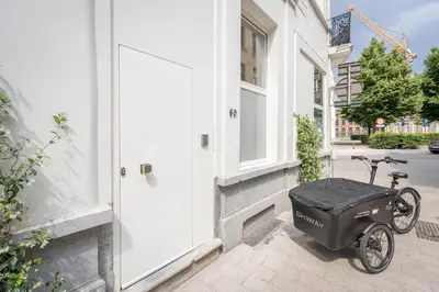 a scooter parked outside of a building with a door at SHWAY - The Suit in Antwerp