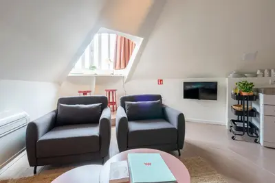 a living room with two chairs and a table at SHWAY - The Suit in Antwerp