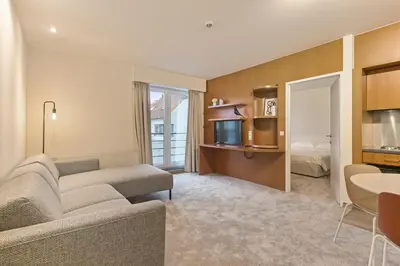 a living room with a couch and a bed at Verac Flats in Zaventem
