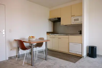 a small kitchen with a table and a microwave at Verac Flats in Zaventem