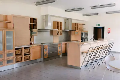a large kitchen with wooden cabinets and a counter at Verac Flats in Zaventem