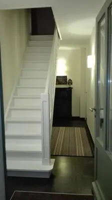 a staircase in a house with a stair case at little cottage in Lasne