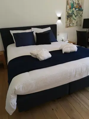 a large bed with two white pillows on it at Elingenhof in Elingen