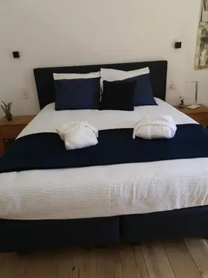 a large bed with two pillows on top of it at Elingenhof in Elingen