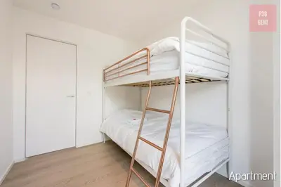 a bunk bed in a room with a ladder at Lovely & Stylish accommodations at P36 Gent, near the Center in Ghent
