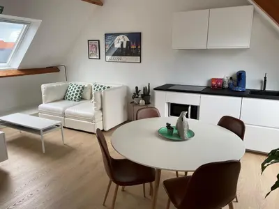 a living room with a white table and chairs at Lovely & Stylish accommodations at P36 Gent, near the Center in Ghent