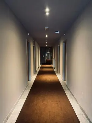 an empty hallway with a long hallway sidx sidx sidx at HOTEL BORNEM in Bornem