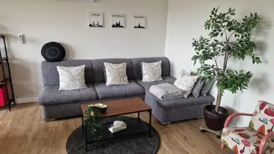a living room with a couch and a table at Cocoon in East-Brussels in Wezembeek-Oppem