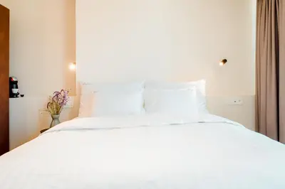 a white bed with white sheets and pillows at The Librarian by Domani Hotels in Ghent