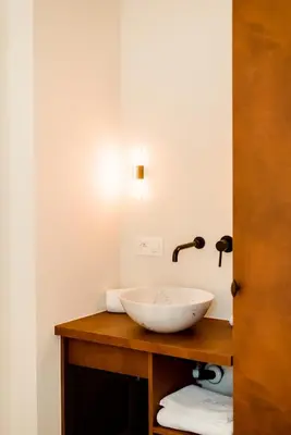 a bathroom with a bowl sink on a wooden counter at The Librarian by Domani Hotels in Ghent