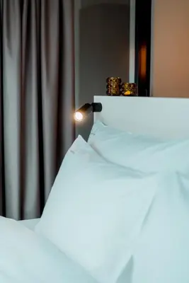 a close up of two beds with rings on top at The Librarian by Domani Hotels in Ghent