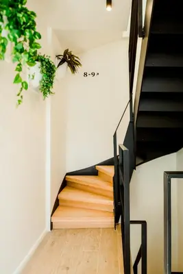 a staircase in a house with wood treads at The Librarian by Domani Hotels in Ghent