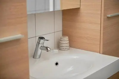 a bathroom sink with a faucet on a counter at De Statie in Brecht