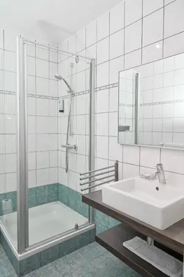 a bathroom with a sink and a shower and a tub at De Statie in Brecht