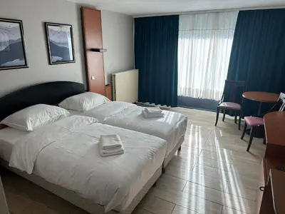 a hotel room with two beds with towels on them at Hotel EUROPACITY in Brussels