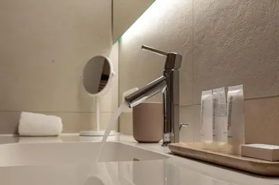 a bathroom with a sink with water pouring from a faucet at B&B El Bayo in Ravels