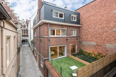 an apartment building with a garden on the side of it at Gepetto's - Beautiful stay in the Historic centre of Ghent - in Ghent