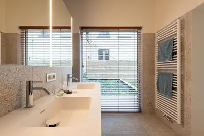 a bathroom with a sink and a large window at Gepetto's - Beautiful stay in the Historic centre of Ghent - in Ghent