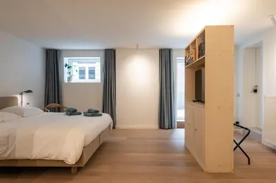 a bedroom with a bed and a tv in a room at Gepetto's - Beautiful stay in the Historic centre of Ghent - in Ghent