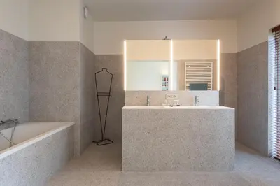 a bathroom with a tub and a sink and a mirror at Gepetto's - Beautiful stay in the Historic centre of Ghent - in Ghent