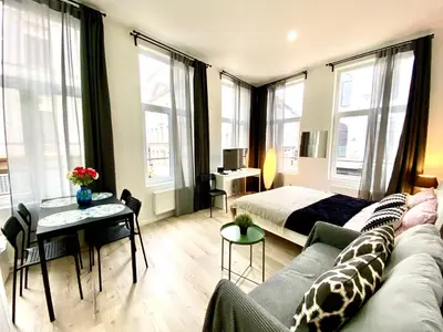 a living room with a couch and a bed at BONJOUR Apartments Сentre 3 in Antwerp