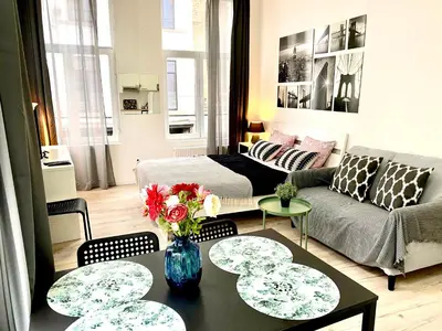 a living room with a couch and a table at BONJOUR Apartments Сentre 3 in Antwerp