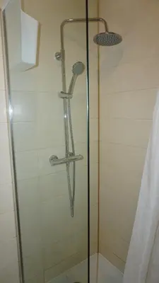 a shower with a glass door in a bathroom at BONJOUR Apartments Сentre 3 in Antwerp