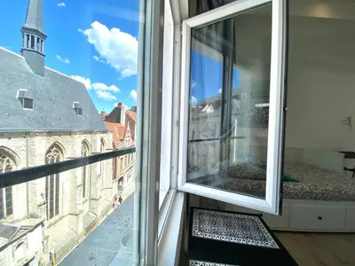a window with a view of a city at BONJOUR Apartments Сentre 3 in Antwerp