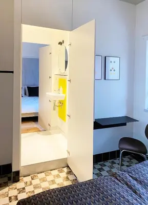 a room with a bathroom with a sink and a mirror at B&B Expo House in Antwerp
