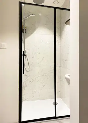 a shower with a glass door in a bathroom at B&B Expo House in Antwerp