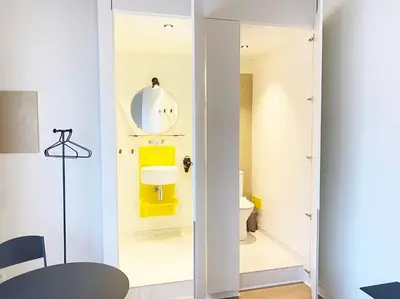 a small bathroom with a toilet and a mirror at B&B Expo House in Antwerp