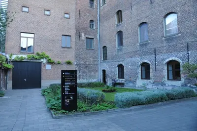 a sign in front of a brick building at Het Rustpunt in Ghent