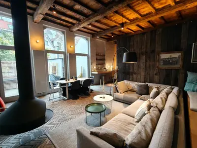 a living room with a couch and a table at Het Rustpunt in Ghent