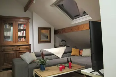 a living room with a couch and a tv at Brussels Downtown in Brussels